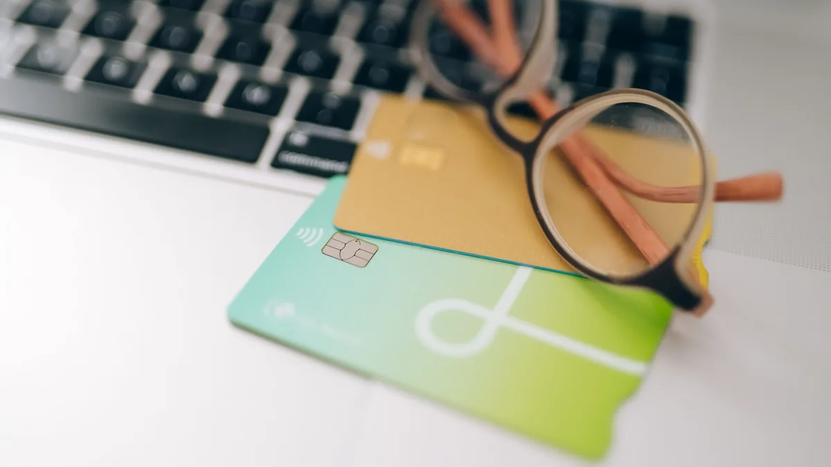 A court application form beside a bank card, illustrating checking the right fee before submitting an application